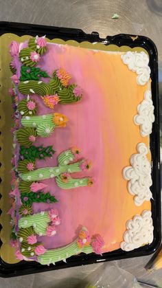 the cake is decorated with flowers and green plants on it's side, along with other decorations