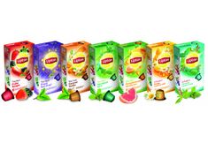 four boxes of lipton's fruit juice are lined up on a white background