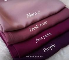 four sheets stacked on top of each other in purple, pink and mauve colors