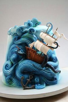 a cake that looks like an ocean wave with a ship on top