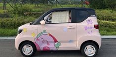 a pink car with hello kitty painted on it's side