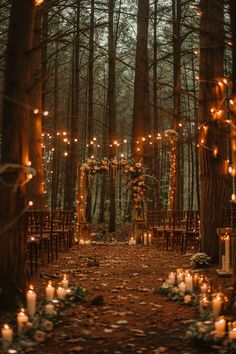 an outdoor wedding setup with candles and chairs in the woods at night, surrounded by trees