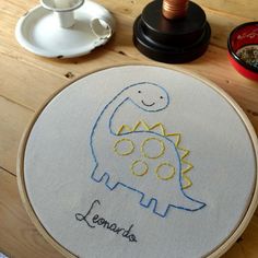 a cross stitch pattern with a dinosaur on it