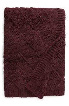 a maroon knitted blanket on a white background