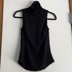 Nwt. Black Turtleneck Sleeveless Sweater By Redhaute. Features Paneled Sides. Black Stretch Sweater Vest, Black Stretch Sleeveless Sweater Vest, Chic Fitted Sleeveless Sweater Vest, Black High Neck Tank Top For Layering, Chic Black Turtleneck Tank Top, Fitted Sweater Vest For Night Out, Black High Neck Tank Top For Night Out, Black Turtleneck Tank Top For Fall, Chic Stretch Tank Vest