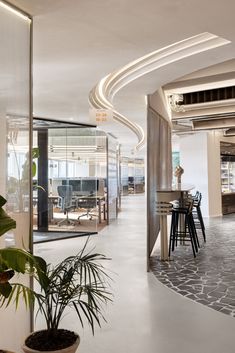 the interior of an office building with plants and chairs