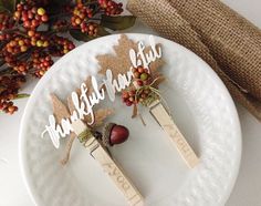 two wooden forks with thanksgiving decorations on them