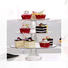 three tiered cake stand with cupcakes on it