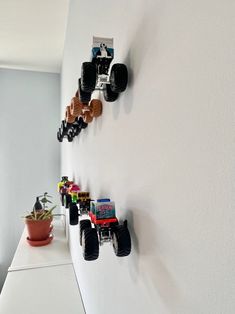 there are many toy cars hanging on the wall