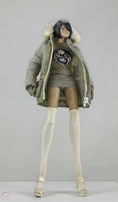 a mannequin dressed in winter clothing and boots, with her hands on her hips