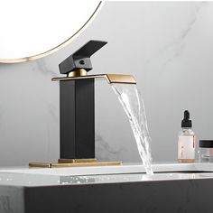 a faucet with water running from it in front of a mirror and other bathroom items