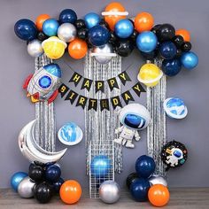 an astronaut themed birthday party with balloons and decorations