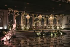 an elaborately decorated hall with chandeliers and lights