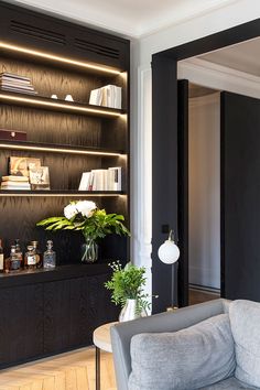 a living room filled with furniture and bookshelves