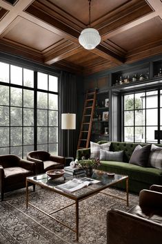 a living room with couches, chairs and windows in the wall to ceiling wood paneling