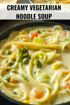 creamy vegetarian noodle soup with broccoli and carrots in a black bowl