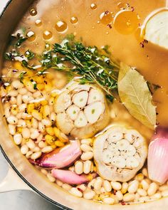 a pot filled with soup and vegetables on top of a table