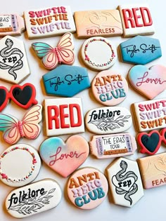 many decorated cookies are displayed on a white surface with the words red, love, and heart