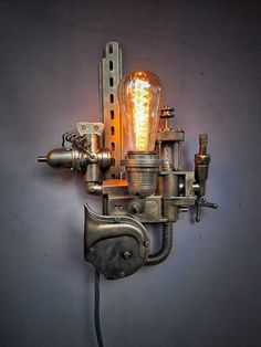 a light bulb is attached to the side of a wall mounted device with an electrical cord