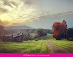 an old barn sits in the middle of a grassy field with a path leading to it