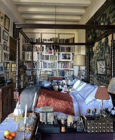 a bed room with a neatly made bed and lots of books