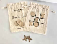 two bags with wooden crosses and buttons on them