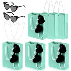 four bags with sunglasses on them and pearls hanging from the handles, all in different colors