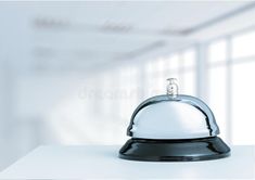 a silver clochet sitting on top of a white table in an empty room