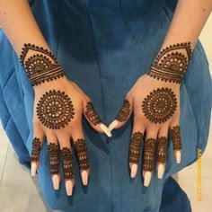 two hands with henna designs on them