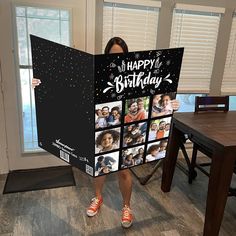 a woman is holding up a birthday card