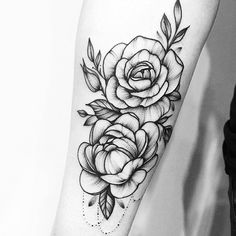 a black and white rose tattoo on the arm