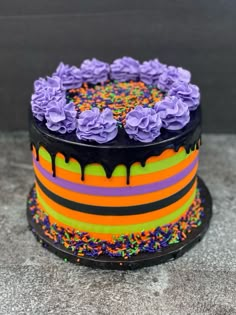 a colorful cake with sprinkles and flowers on top