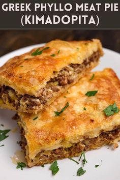 two pieces of greek phylo meat pie on a white plate with parsley