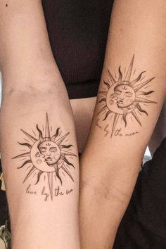 two people with sun and moon tattoos on their arms, both holding each other's hands