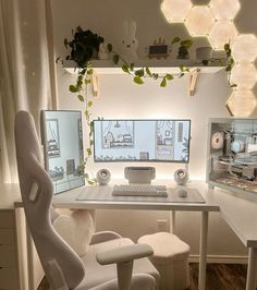 a white desk with two monitors and a keyboard