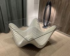 a modern glass table with wavy lines on it