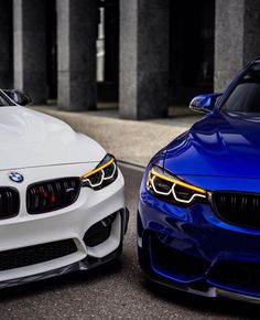 two white and blue cars parked next to each other