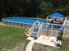 an above ground swimming pool with steps leading up to it and a deck in the middle