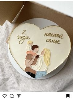 a cake in the shape of a heart with an image of two people on it