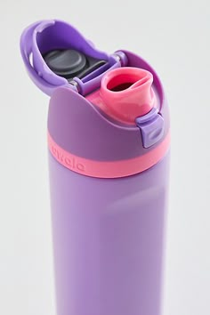 a purple and pink water bottle sitting on top of a table