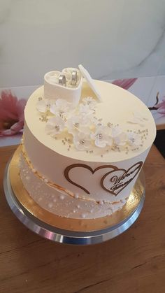 a wedding cake with white and gold decorations