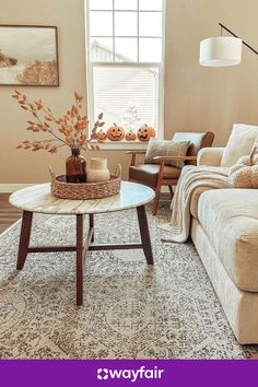 a living room with couches, chairs and a coffee table in front of a window