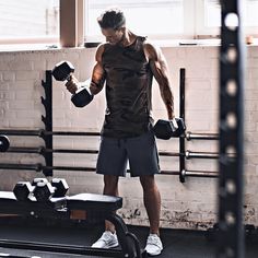 a man is standing in the middle of a gym