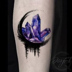 an artistic tattoo with purple crystals on the arm