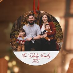 a family ornament hanging from a christmas tree