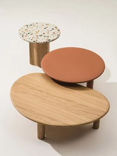 three tables with different shapes and sizes on each one, all made out of plywood