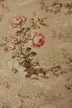 an old rug with pink flowers on it