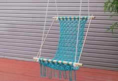 a blue hammock hanging in front of a garage door with the words how to make a crocheted hammock