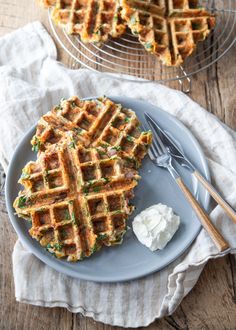 two waffles on a plate with whipped cream