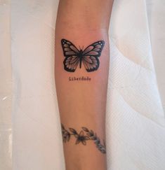 a small butterfly tattoo on the arm